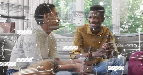 Duo sitting sofa woman talking and starting overlay obscuring them across frame with beers for tech