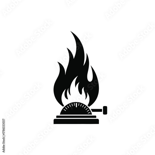 Black gas stove burner with flames and dial fire