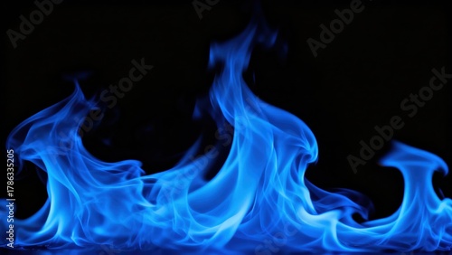 Vivid blue flames dance against a deep black background creating an abstract energetic visual
