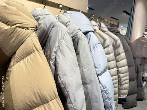 New season down jackets hanging in row.