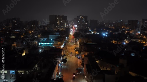 Wallpaper Mural Aerial night view of Lima, Peru flying towards the city center with car traffic moving on the street. Cityscape with illuminated buildings Torontodigital.ca
