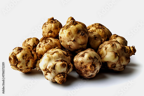Heap of fresh jerusalem artichokes on a white background