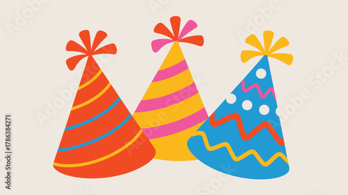 Three colorful and festive birthday party hats with pom poms on top arranged in a pleasing composition against a neutral background