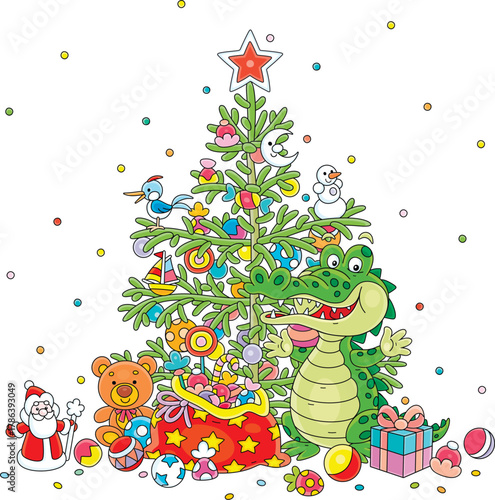 Funny green crocodile with its gifts and decorated Christmas fir tree with holiday balls, toys, sweets and garlands, vector cartoon illustration on white