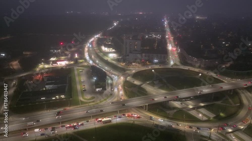 Night roundabout traffic, city circle aerial timelapse, rush hour
