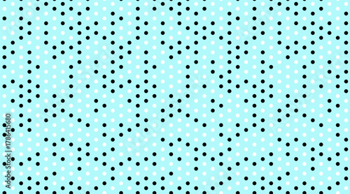 Abstract pastel blue background with a repeating pattern of black and white polka dots.  Ideal for website banners, social media posts, or textile design.