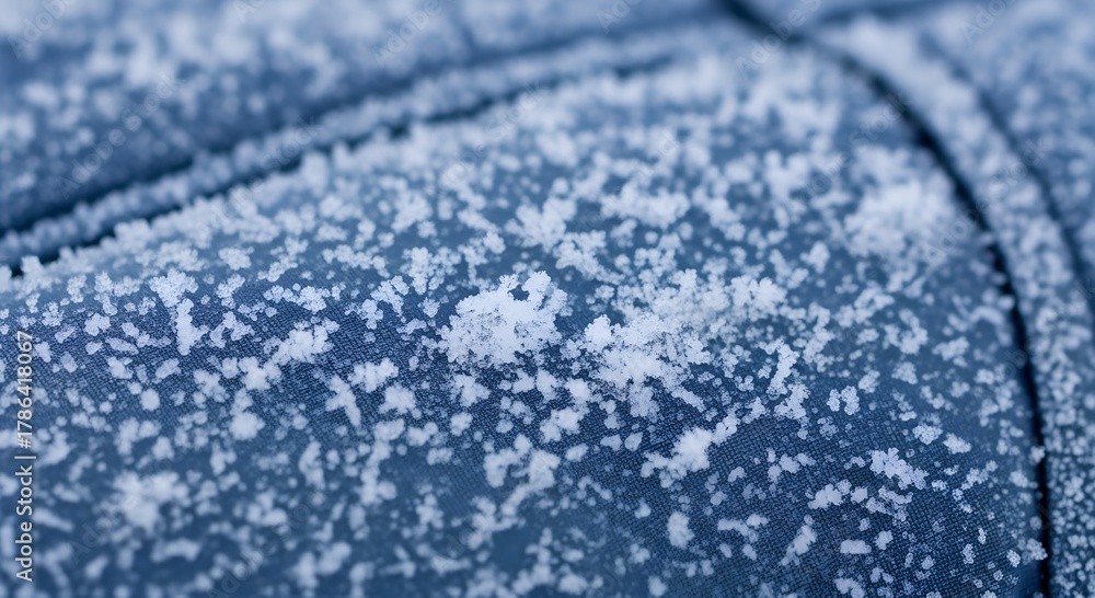 Obraz premium Frosty texture on blue surface with snowflakes in winter 
