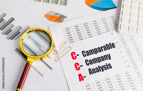 Fényképezés Comparable company analysis acronym written on paper with financial charts, magn
