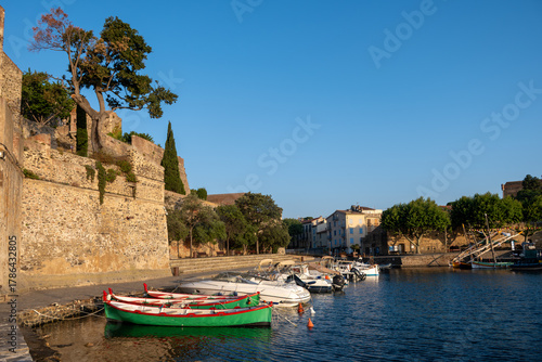 Fototapeta Naklejka Na Ścianę i Meble -  View of colourful Collioure, narrow streets and yellow, pink, orange houses, summer vacation destination town with historical buidings and beaches, Pyrenees-Orientales, France