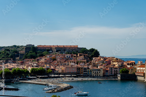 Fototapeta Naklejka Na Ścianę i Meble -  View of colourful Collioure, narrow streets and yellow, pink, orange houses, summer vacation destination town with historical buidings and beaches, Pyrenees-Orientales, France