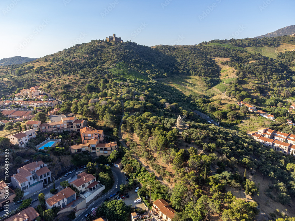 Obraz premium Aerial view of colourful Collioure, narrow streets and yellow, pink, orange houses, summer vacation destination town with historical buidings, beaches, Pyrenees-Orientales, France