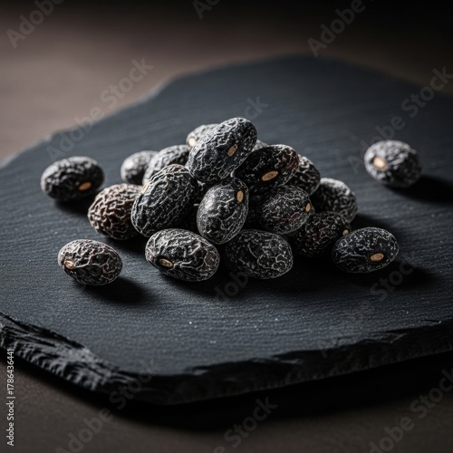 Pile of Black Beans on a Dark Slate Surface.