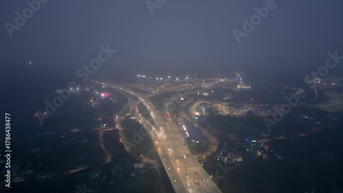 Night highway junction traffic, city circle aerial timelapse, rush hour