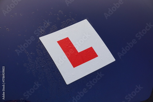 L plate on car of new driver. Learner badge of recently passed test