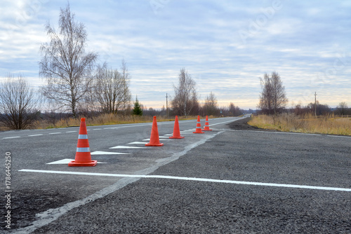 View of traffic cones at a road repair site. Fresh road markings.