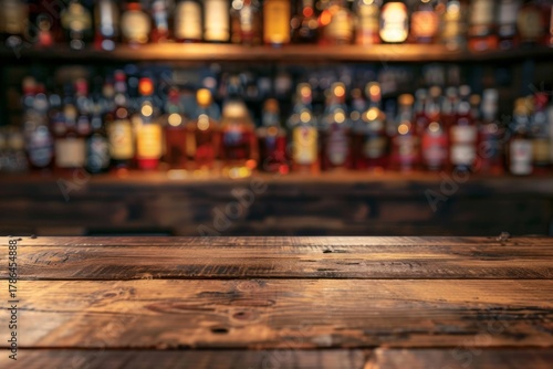 Wooden bar counter with blurred liquor bottles in background