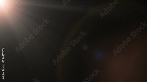The appearance of rays of light with glare on a black background. Animation.