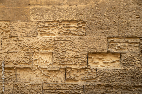 Old stone wall with limestone erosion closeup in Lecce, Italy