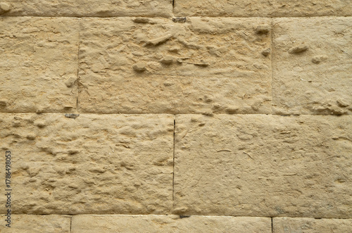 Old stone wall with limestone erosion close up in Lecce, Italy