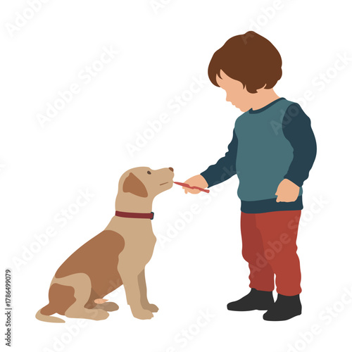 Little boy giving treat to his dog