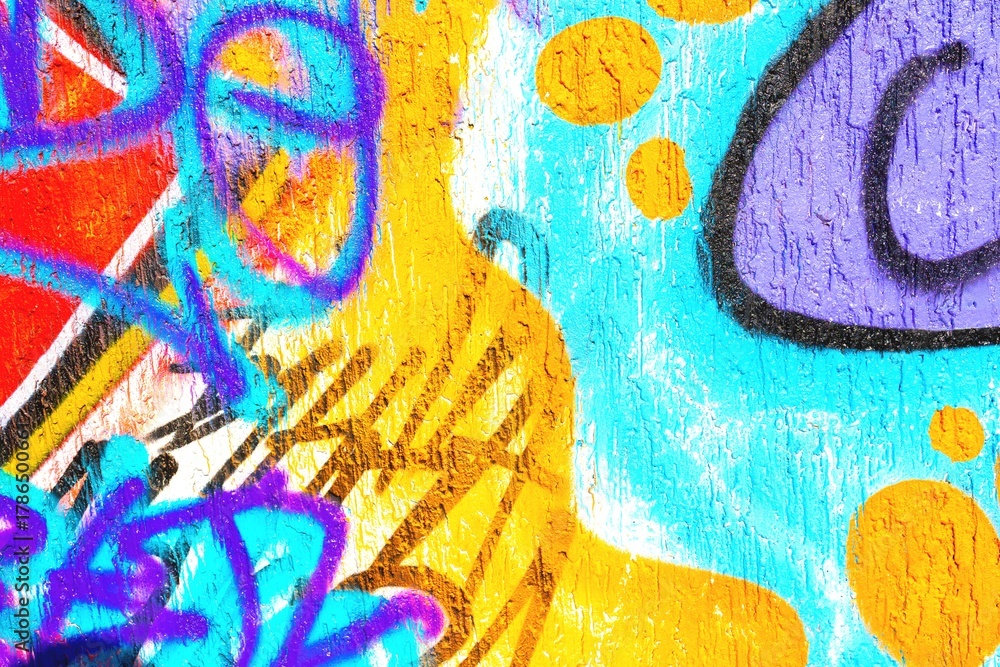 Obraz premium Vibrant graffiti abstract in neon orange, blue, purple. 90s urban style, fluorescent clash, textured paint. Street art, murals, urban visuals, creative banner.