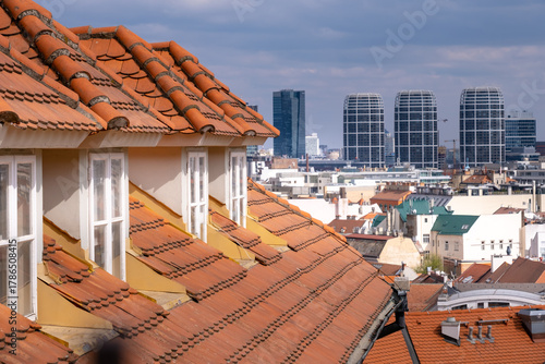 Photography The view features traditional rooftops in Bratislava with modern buildings in the distance, showcasing the city's architectural contrast on a clear day