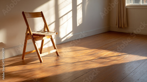 Empty chair by window — sun...