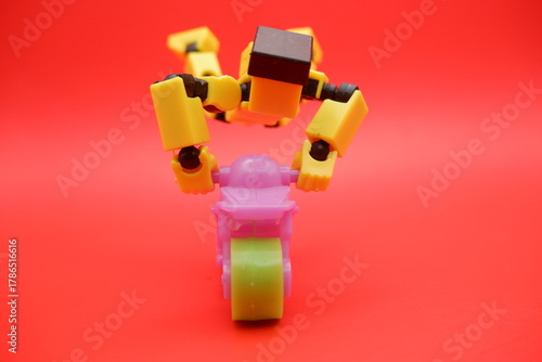 Toy Action Figure Performing Stunt on Mini Motorcycle