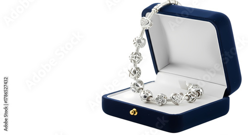 Elegant silver charm bracelet sparkling with intricate designs and a heart pendant nestled in a luxurious velvet jewelry box, a perfect gift.