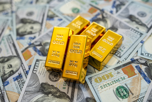 Shiny gold bars and dollar currency bills symbolizing rich economy, fortune, and elegant success