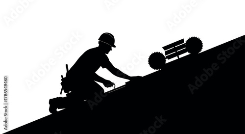 Silhouette of a male construction worker in a hard hat kneeling on a sloped roof with tools, emphasizing manual labor and construction themes.