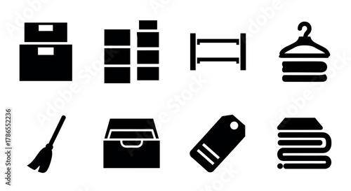 Set of black silhouette icons depicting storage and organization items including boxes, shelves, a broom, a drawer, a tag, and neatly folded towels on a hanger.