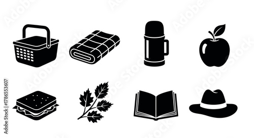 Black silhouette icons of outdoor essentials, including a picnic basket, blanket, thermos, apple, sandwich, leaf, open book, and hat arranged in two rows.