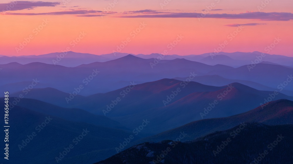 Fototapeta premium Mountain ranges revealing vibrant colors during sunset, creating a serene, layered atmospheric landscape at dusk