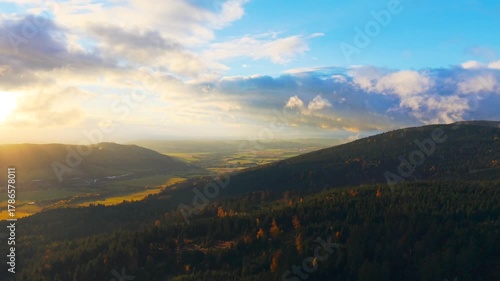 Witness a breathtaking autumn sunrise in the Orlicke Mountains, showcasing vibrant colors and serene landscapes as the sun rises over the horizon. Experience nature's beauty.