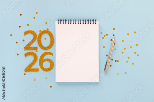New Year 2026 planning concept with notebook and golden numbers for your goals, plans, resolutions. Flat lay style. Christmas planning concept with space for text