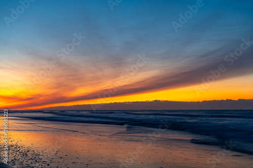 Colorful Shelf Cloud over Beach and Sea at Twilight