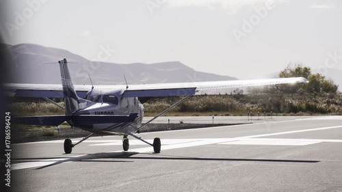 Sunlight bouncing off small cessna airplane preparing to take off on runway