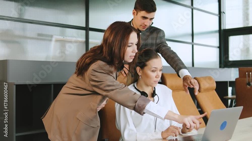 Close-up of business consultants in a modern office setting providing technical support to clients using computers and headphones