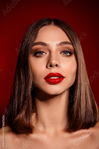 Wallpaper Mural Portrait of a confident young woman with bold red lipstick and sleek brown hair against a rich red background Torontodigital.ca