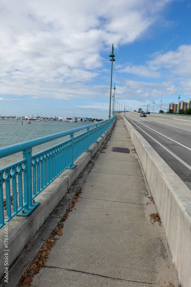 Fototapeta premium Walkway with fancy rail along the roadway of a bridge over a waterway