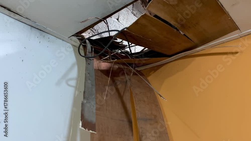 The house ceiling made of plywood peeled off due to rainwater. The house ceiling leaked. Water came out of the peeled off ceiling. House The plywood ceiling peeled off	