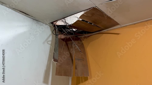 The house ceiling made of plywood peeled off due to rainwater. The house ceiling leaked. Water came out of the peeled off ceiling. House The plywood ceiling peeled off	