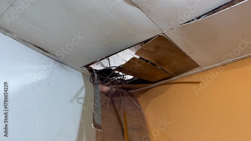 The house ceiling made of plywood peeled off due to rainwater. The house ceiling leaked. Water came out of the peeled off ceiling. House The plywood ceiling peeled off	