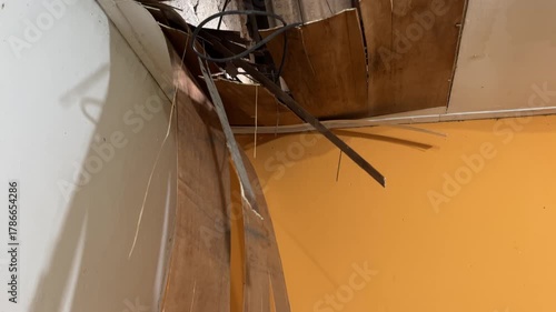 The house ceiling made of plywood peeled off due to rainwater. The house ceiling leaked. Water came out of the peeled off ceiling. House The plywood ceiling peeled off	