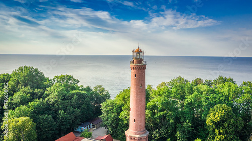 Lighthouse and birds on sun...