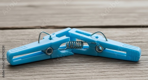 Whimsical meeting of small pastel blue clothespins on wooden surface