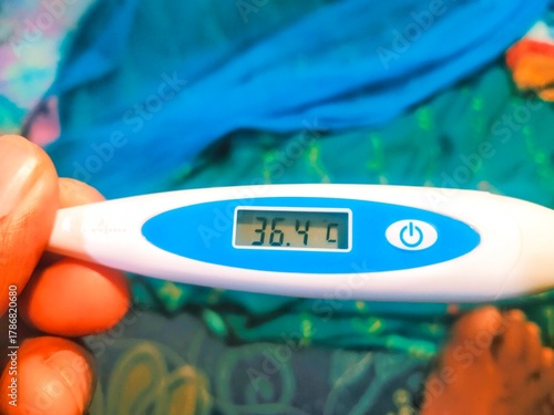 A personal health check showing a digital thermometer with a reading of 36