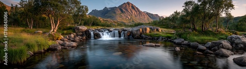 Serene Icelandic Landscape with Golden Waterfall, Long Exposure Silky Flow, Majestic Mountains and Colorful Sky, Perfect for Geography Education or Wallpaper Design.
