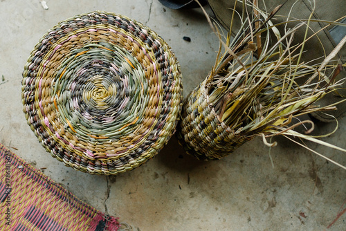 Multicolored woven basket lying on the concrete floor.